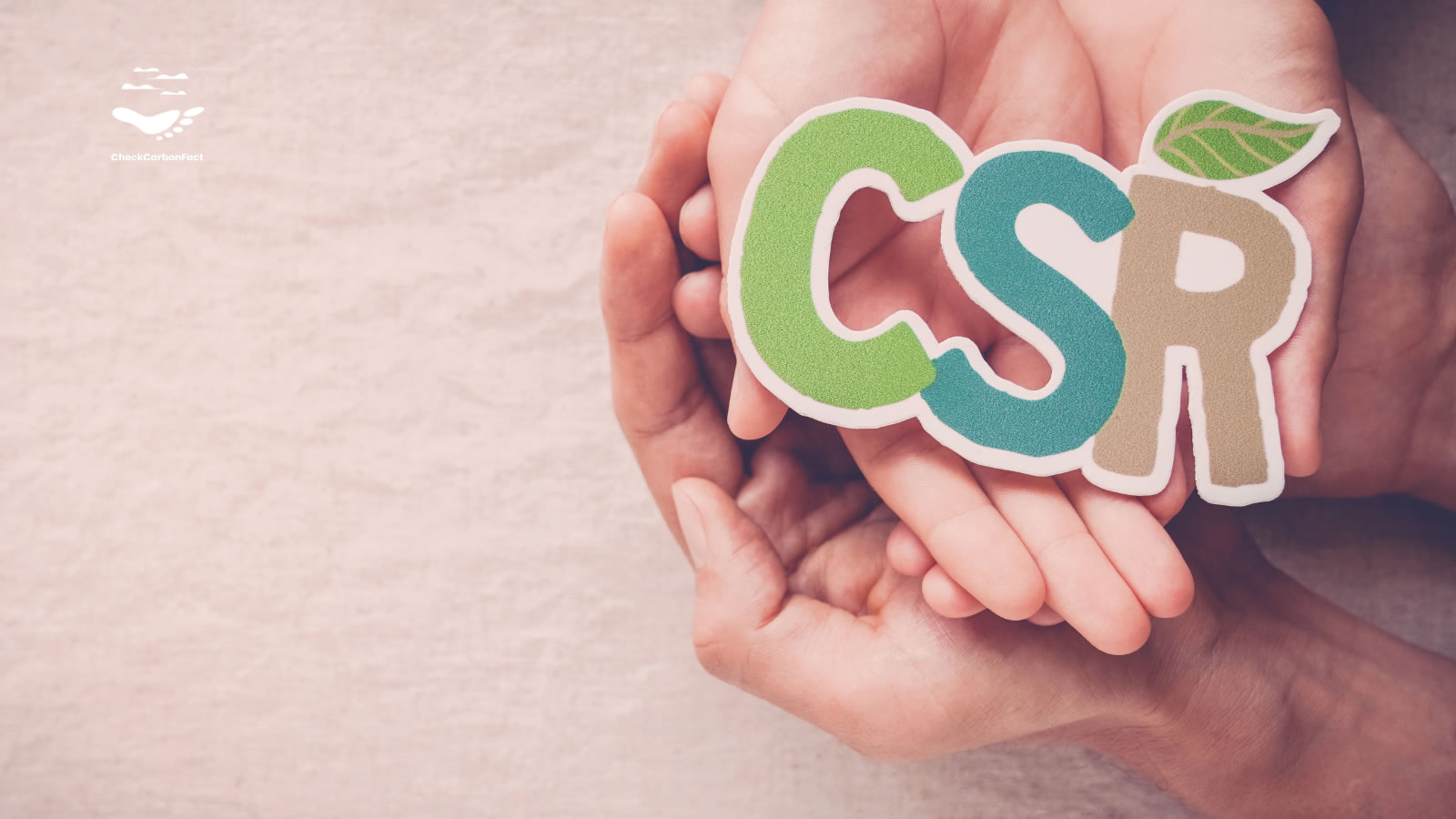 Two hands holding the letters “CSR”